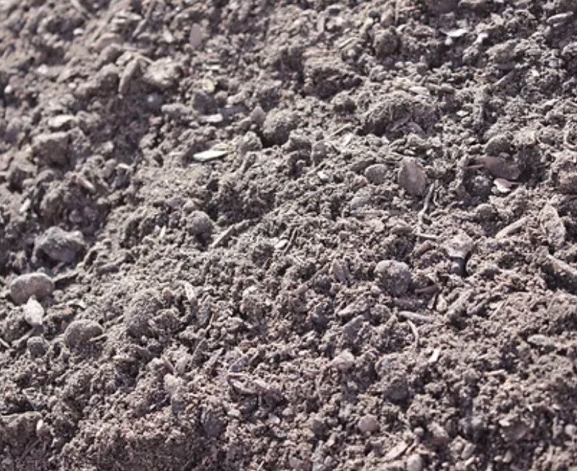 Fine soil conditioner material held in a hand